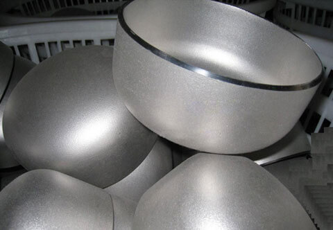 A stack of stainless steel bowls and plates on a kitchen counter