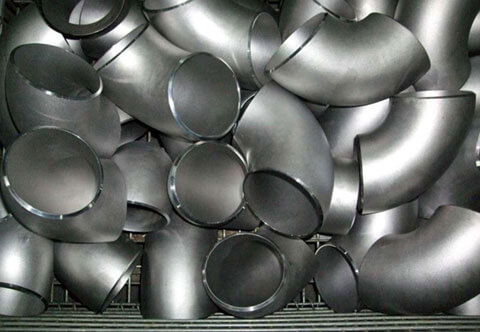 A pile of shiny, group of metallic pipe fittings