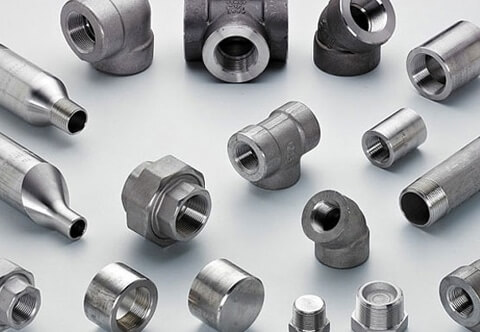 Various metal pipe fittings and connectors, including elbow joints, straight connectors, and caps, arranged on a light gray background