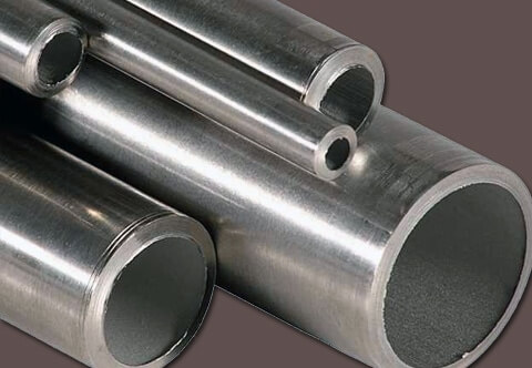 Close-up image of five metal pipes of various diameters arranged together.
