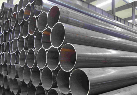 A warehouse filled with a large pile of steel pipes