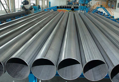 Steel pipes lined up in a factory setting