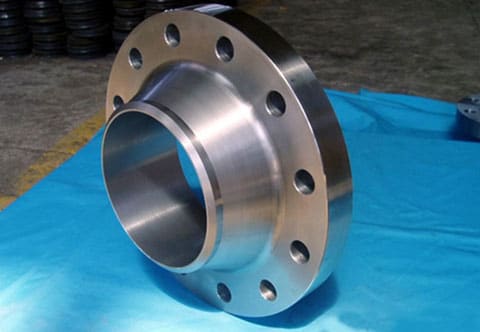 A stainless steel flange placed on a blue table